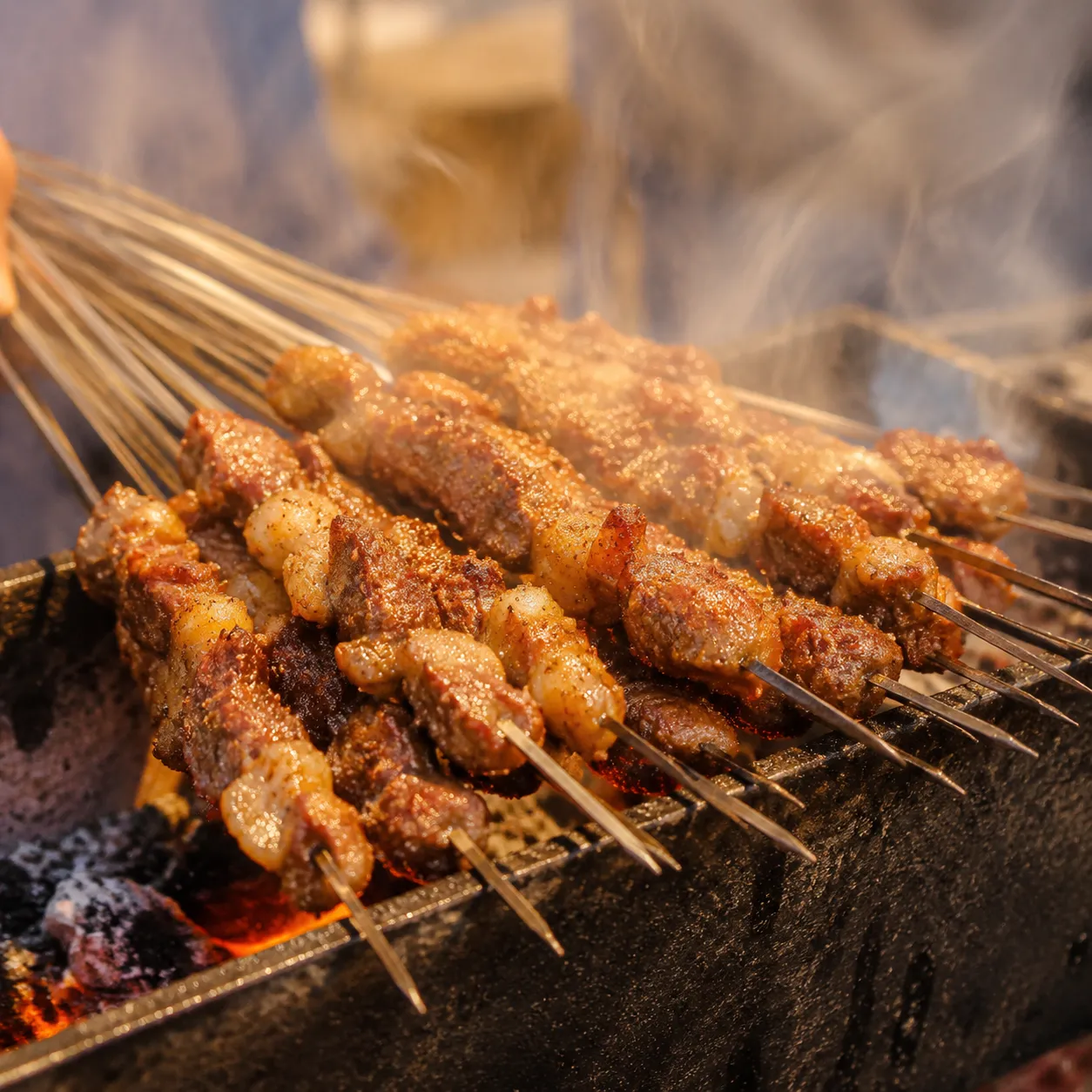 Lamb Skewers — Smoky, cumin-heavy grilled lamb with a charred exterior and 
